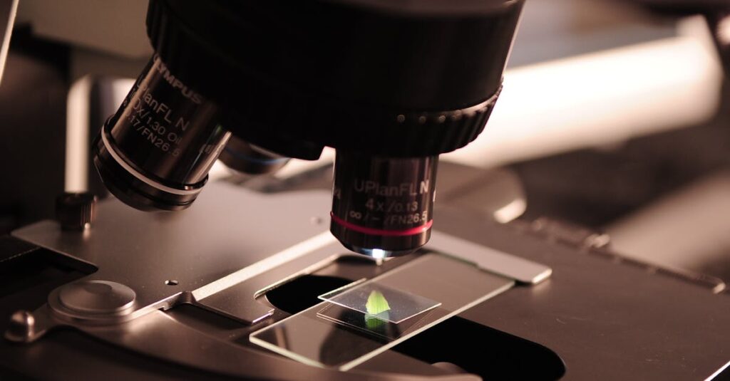 Detailed view of a microscope with a slide in a laboratory environment.